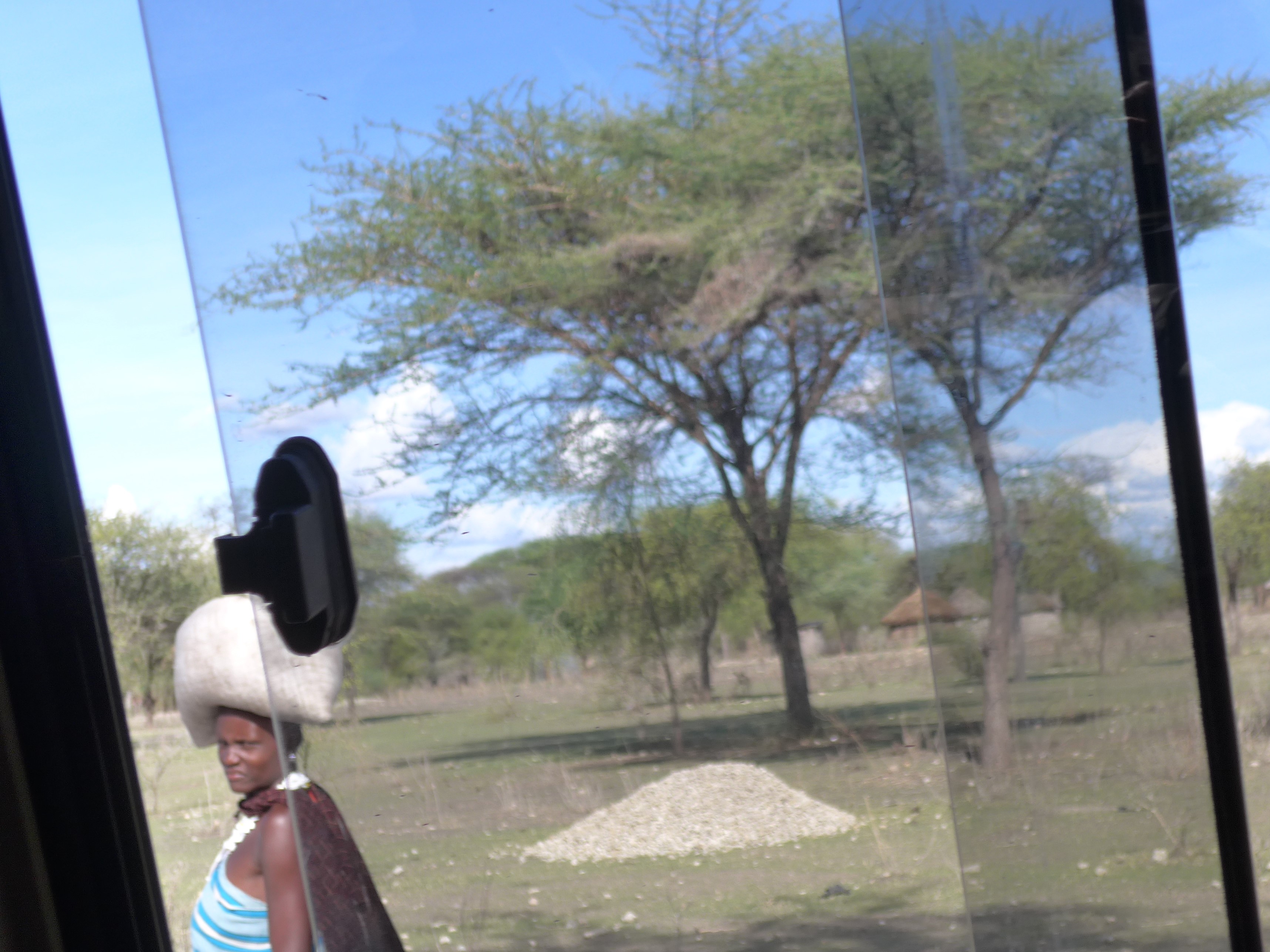 Maasai woman carrying sack on head